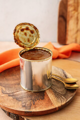 Tin can of boiled condensed milk on table