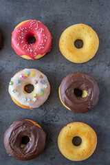 Donuts pattern. Top view of assorted glazed donuts.