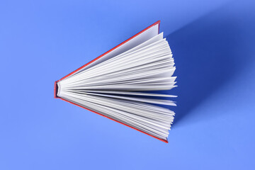Blank book on color background