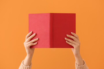 Woman with blank book on color background