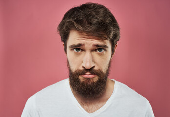 Man with a beard on a pink background sad face emotions model