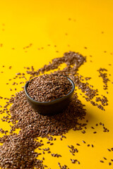 Flax Seeds  in marble bowl on yellow background. Modern ingredients background. Copy space