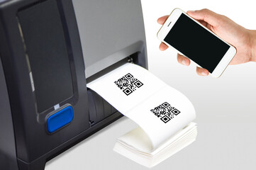 Hand holding smart phone with barcode label printer. When scanning the QR Code, it will show the word "text".