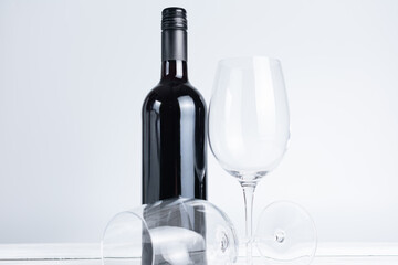 Bottle of wine and glass on white