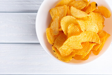 Tasty potatoes chips in bowl