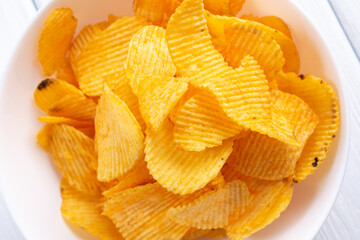 Tasty potatoes chips in bowl