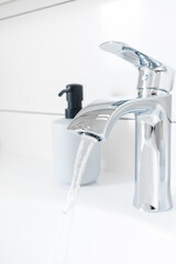 New chrome or steel mixer tap for bathroom sinks