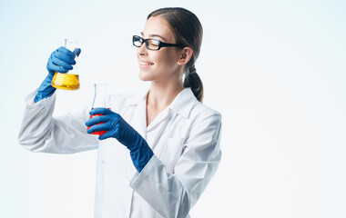 woman doctor professional with vaccine flasks in hand analyzes