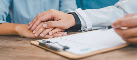 Close-up of the psychiatrist's hand holding the patient's hand. To encourage and comfort the patient