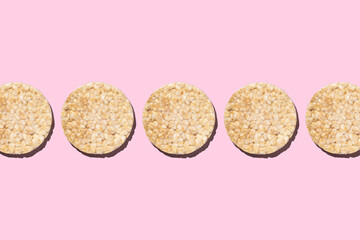 Round gluten-free rice flour crispbread on pink background