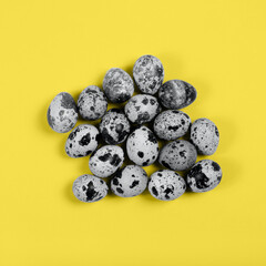 The easter background with the quail eggs in the trendy illuminating yellow and ultimate gray colors of the year.