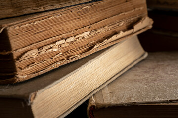 Stacks of old multi-format books with scuffs. Low depth of field photography
