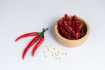 Red fresh and dried hot chilli in wooden bowl - 418254162