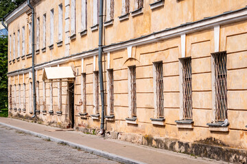 Old two-storey building with metal bars on the windows.