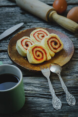 slice of Homemade Sweet roll with Strawberry jam on wooden background
