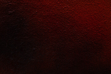 Fototapeta na wymiar Textured background in dark red wall