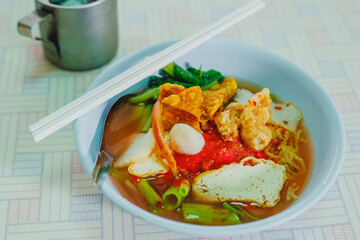 Pink seafood flat noodles with wide rice noodles. or We called Yen-ta-fo in Thailand