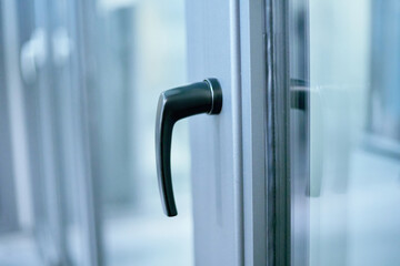stylish metal handle on the window frame.