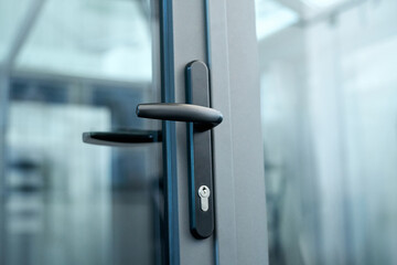 stylish door handle with lock on the glass door.