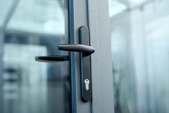 Stylish Door Handle With Lock On The Glass Door.