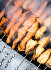 Fish kebab on skewers on the grill in winter