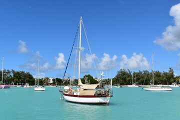 General view of boats moored in the beautiful Grand Bay lagoon in Mauritius, amazing colors. Vacations background.