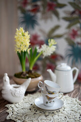 blooming hyacinths and vintage cups on the table