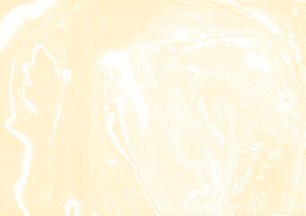 Abstract artsy backdrop. Decorative golden yellow acrylic marble texture. Eco-friendly theme, festive brand, creative poster. Marbling background. Liquid ink on wet surface. Light yellow marbled paper