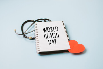 World Health Day, medical and healthcare. Stethoscope and text World Health Day in open notepad on blue background