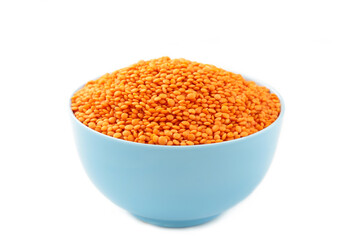 Red lentils in bowl isolated on a white background.