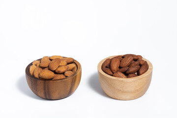 Roasted almond in wooden bowl on white background