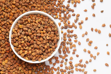 Close up of Organic chana or chickpea (Cicer arietinum) or on a ceramic white bowl with the gradient background of whole white Bengal gram dal. Top view 