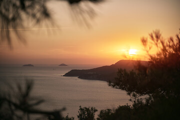 sunset  on the distant peninsula over the sea