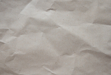 Naklejka premium Crumpled brown kraft paper texture background of paperboard sheet.