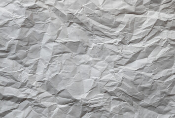 Crumpled brown kraft paper texture background of paperboard sheet.