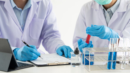 Team of Medical Research Scientists or researcher in lab coat testing their experimental in Modern laboratory.
