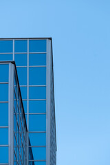 Fototapeta na wymiar Abstract texture of blue glass modern building skyscrapers. Business background. Copy space. Window glass pattern exterior of architecture office building. 