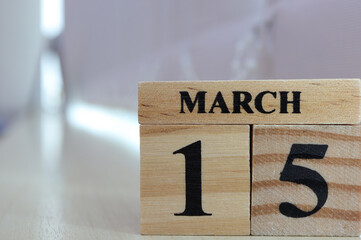 Day 15 of March month, Wooden calendar with date on a table.