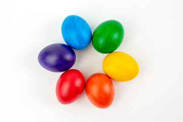 Multicolored eggs on white background