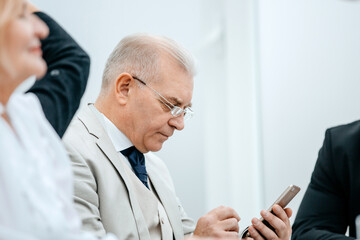 close up. serious businessman reading e-mail on his smartphone.