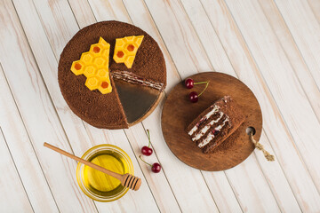 Honey cake with cherries on a white wooden background. Top view with a copy space for the text.