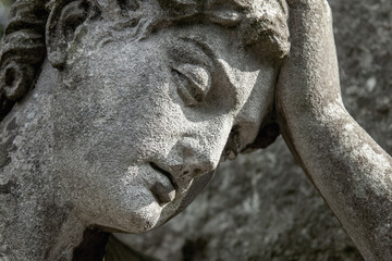 Fototapeta na wymiar Sad angel feeling pain and sorrow. Fragment of ancient. Death, depression, pain and sorrow concept.