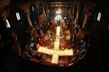 Blagoevgrad, Bulgaria - February 10, 2021: Hundreds of jars of honey rank in the form of the Holy Cross in honor of Saint Haralampiy. The ritual is unique and is made only in Blagoevgrad temple Blesse