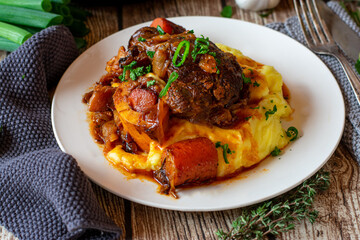 braised beef with vegetables and mashed potatoes