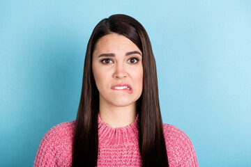 Photo of pretty questioned lady biting lip look camera wear sweater isolated on pastel blue color...