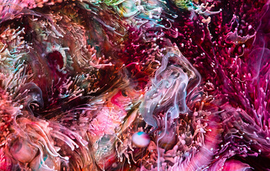 Resin art texture with colorful waves. Fluid backdrop with splashes and swirls. Modern abstract texture with alcohol inks. Bright pigments mixes and overflows on macrophotography wallpaper