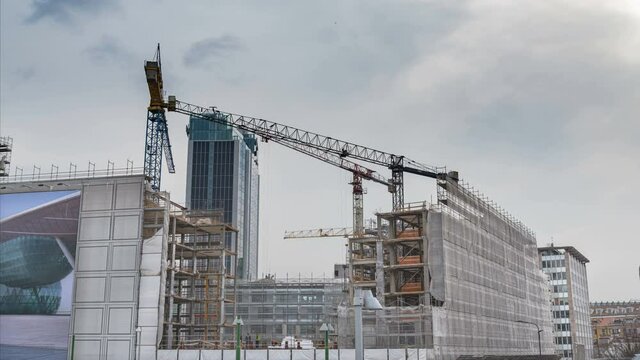 Time lapse of a construction site in Milan, Italy. Exterior of modern building being built. Grey sky on the background.