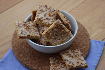 Traditional italian cookies with hazelnut and sugar glaze in a bowl on wooden table
