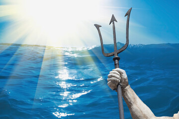 The mighty god of water, sea and oceans Neptune (Poseidon, Triton). Neptun's trident as symbol strength, power and unrestraint. Fragment of an ancient statue. © zwiebackesser