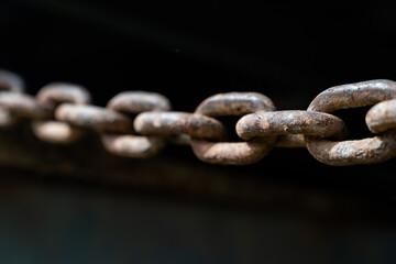 rusty chain from agricultural machinery with dark background